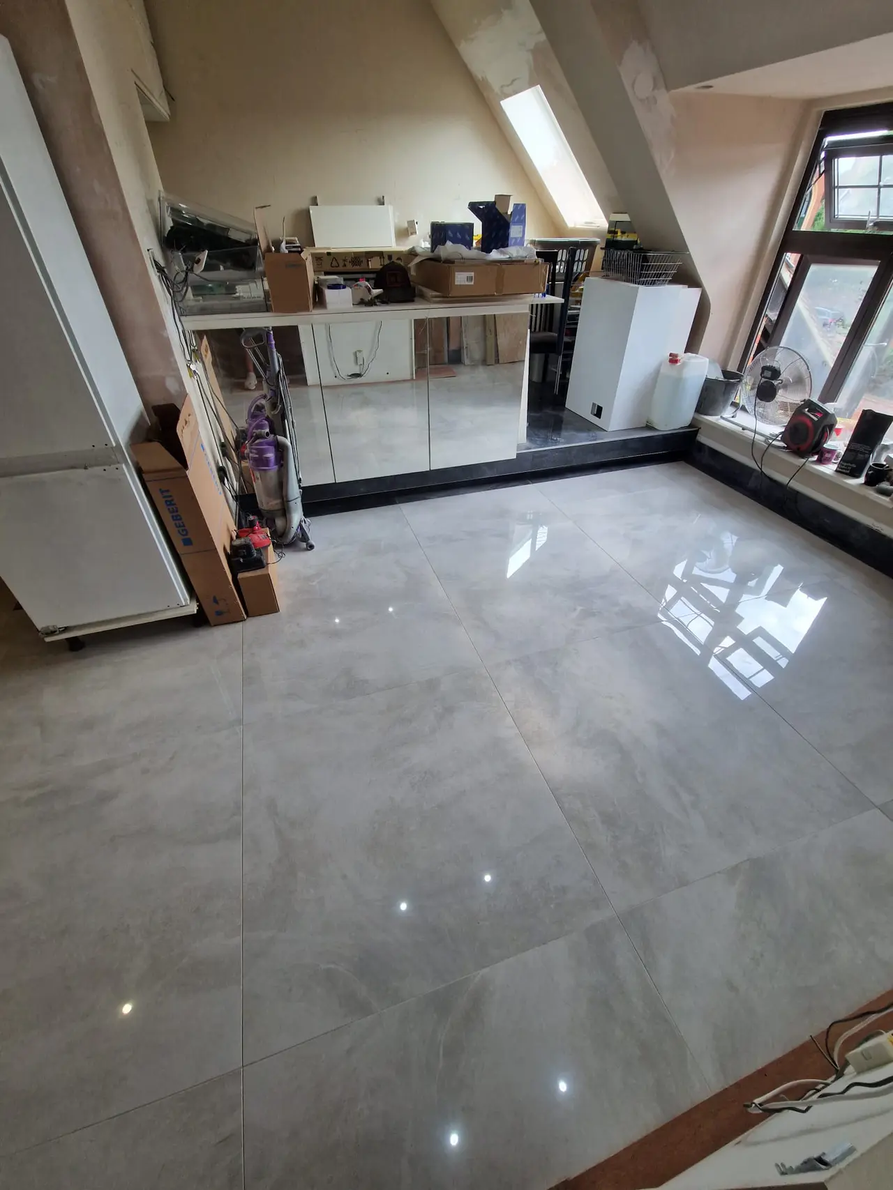 Open-plan interior with a newly laid polished porcelain floor